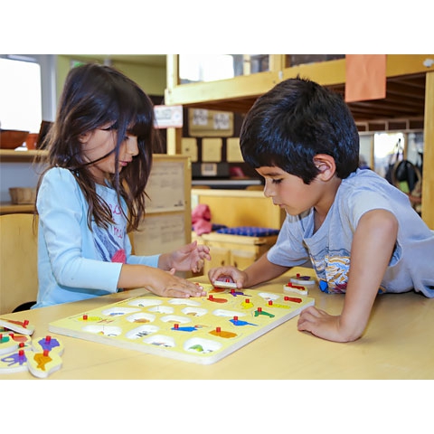 Children working together on a puzzle