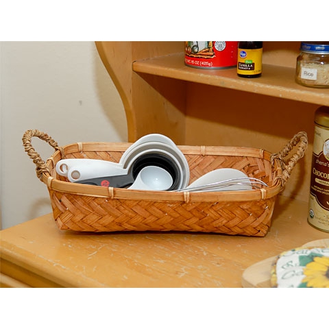 Measuring spoons and kitchen utensils in basket