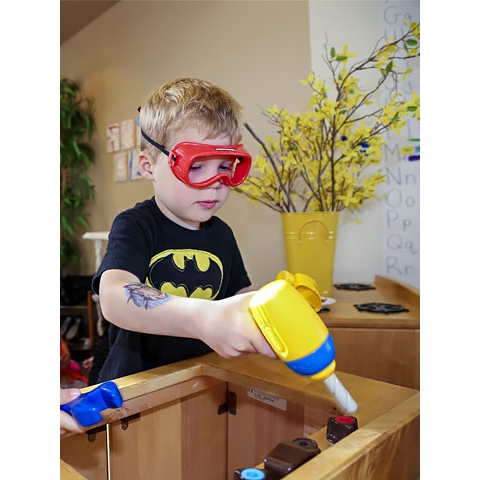Child using play construction materials