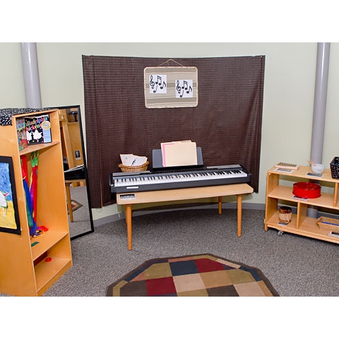 Music area pictures indicate where items belong, with keyboard and instruments on floor shelving
